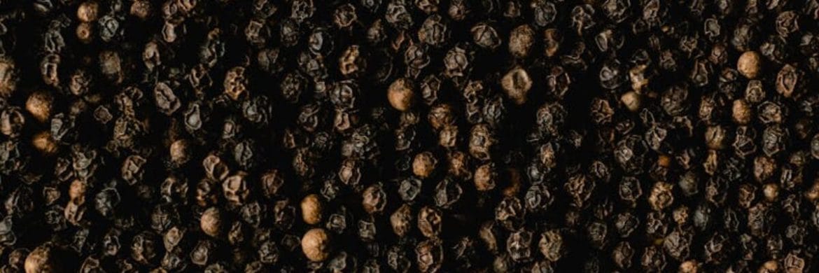 Detailed close-up of black peppercorns showcasing texture and spice quality.
