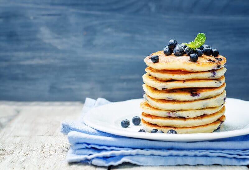 Assiette garnie de pancakes dorés et moelleux, parfumés à la vanille Bourbon et cannelle, servis avec du sirop d'érable
